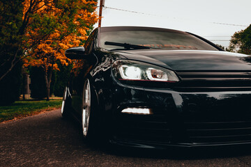 Headlights of a car during fall 