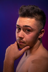 Handsome man posing at the studio without clothes at the torso