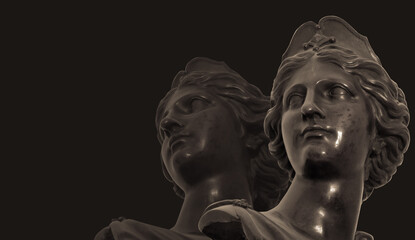 Gypsum copy of ancient statue heads on dark textured background. Plaster sculpture face