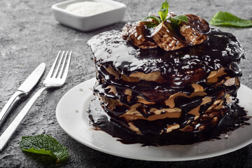 Pancakes and pancakes. Traditional pancakes with chocolate and banana on a dark background.