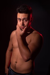 Fototapeta premium Handsome man posing at the studio without clothes at the torso