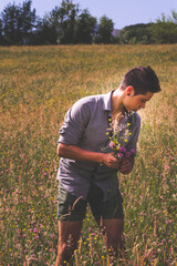 Young man collecting flowers for his lover