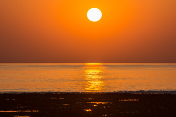 warm orange sun and horizon from the sea in the morning