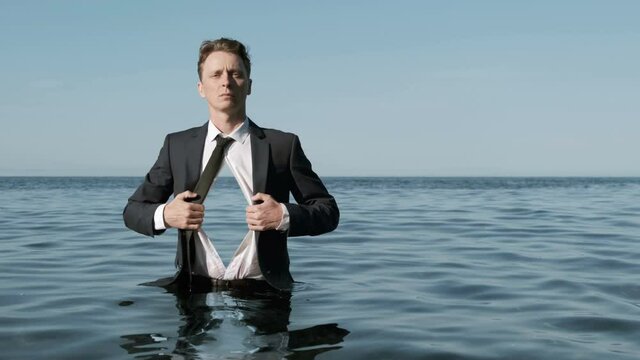 Businessman Standing in Water With Sea Inside a Chest.