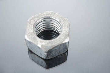 Grunge metal nut close up on gray background