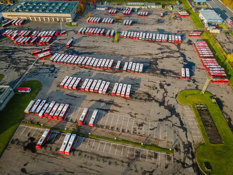 Aerial view of a bus park with many electricity and gasoline powered buses