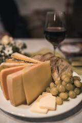 cheese plate with bread and grapes