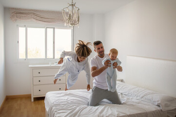 Dad And Sons Playing.
A Dad And His Sons Play Games On The Bed. Lifestyle Family.