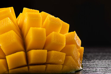 Sweet juicy mango sliced on dark background