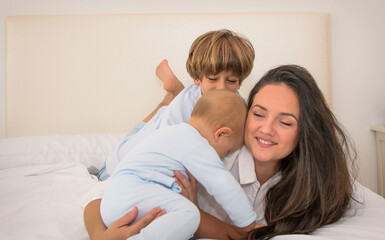 Mom And Children Playing.
A Mother And Her Children Play In Bed. Family Lifestyle.