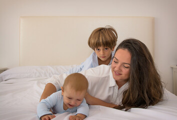 Mom And Children Playing.
A Mother And Her Children Play In Bed. Family Lifestyle.