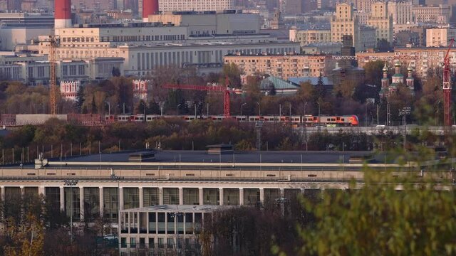 modern electric passenger train moving in the center of Moscow in late autumn