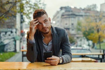 a worried man with a cell phone