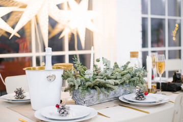 Table served for Christmas dinner in living room, close-up view, table setting, Christmas decoration.