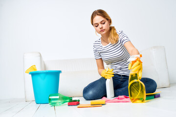 cleaning lady with detergent in hands in the room housekeeping