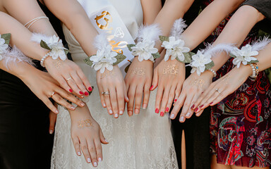 bride holds the sisters by a hand