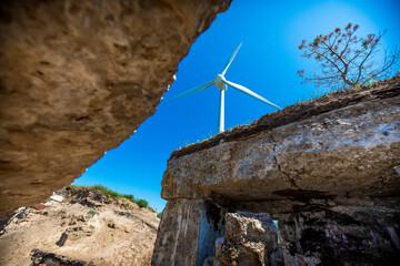 Old war fort ruins on the beach with a wind turbine. Liepaja, Latvia