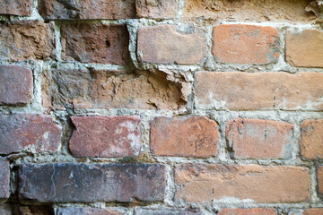 Close-up red damaged brick wall, selective background, copy space