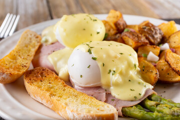 A view of an asparagus eggs Benedict breakfast plate.