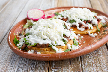 A view of a plate of two sopes, in a restaurant or kitchen setting.
