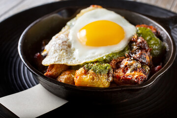 A view of skillet of Brussels sprouts topped with a fried egg.
