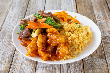 A view of a Chinese fast food 2 item combo plate, featuring orange chicken and beef broccoli.