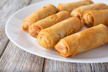 A closeup view of a plate of egg rolls.