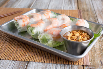 A view of a serving tray of spring rolls.