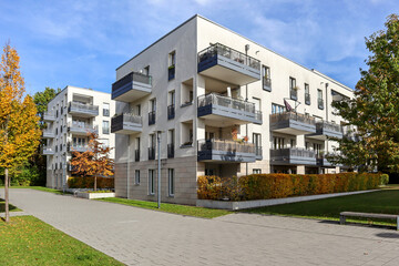 Cityscape with modern residential area, new apartment buildings and green courtyard with pedestrian...