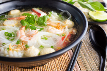 A view of a bowl of seafood pho.