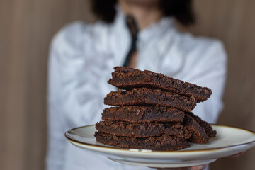 person holding chocolate cake