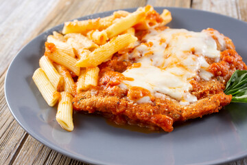 A view of a plate of chicken parmigiana.