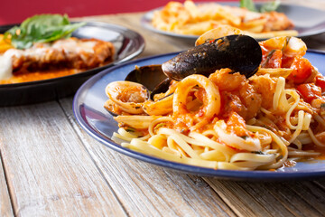 A view of several Italian dishes, featuring linguine pescatore.