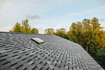 new renovated roof covered with shingles flat polymeric roof-tiles - obrazy, fototapety, plakaty