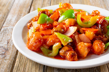 A view of a plate of sweet and sour pork.