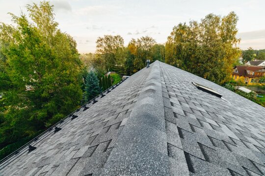 new renovated roof covered with shingles flat polymeric roof-tiles