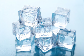 Ice cubes with water drops on blue background