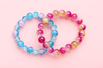Beautiful bracelets on pink background