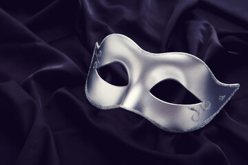 Carnival mask on black fabric background