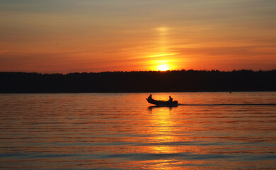 Sunset on the lake. A lone boat.