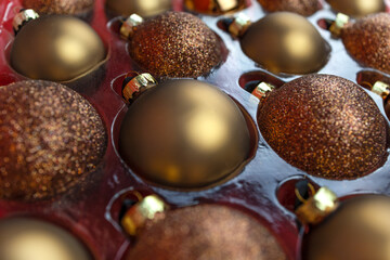 brown Christmas tree balls in a transparent box.