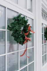 Front door with a Christmas wreath and bows. Home decor