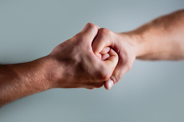 Two hands, isolated arm, helping hand of a friend. Handshake, arms. Friendly handshake, friends greeting. Rescue, helping hand. Male hand united in handshake. Man help hands, guardianship, protection