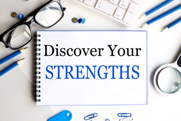 discover your strengths, text on white notepad paper on white background near keyboard