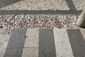 sidewalk and cross road in different colors of stone