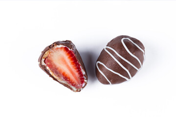 Chocolate truffles with strawberry filling isolated on white background. Closeup photography.