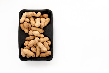 Peanut nuts on white background. From top view.