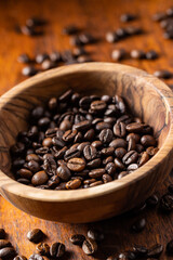 Roasted coffee beans in wooden bowl