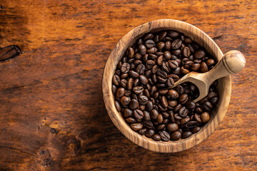 Roasted coffee beans in wooden bowl