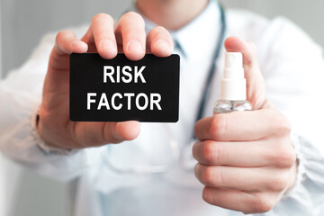 Doctor holding a paper card with text RISK FACTOR and the medicine bottle, medical concept